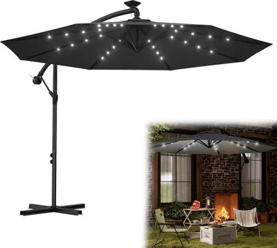 A dark gray cantilever umbrella with LED lights is shown in two views: one isolated on a white background and another in a lifestyle setting on a patio with a fireplace and seating.