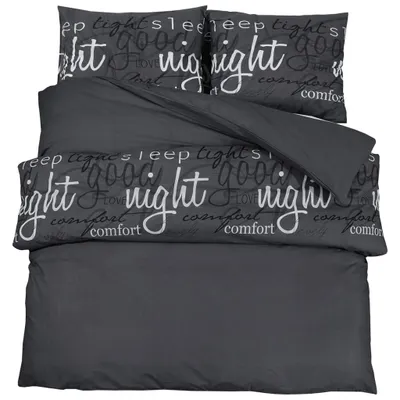 A dark gray duvet cover and pillowcases with text printed on them, laid out on a white background.