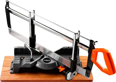 A miter saw is shown on a wooden base against a white background.