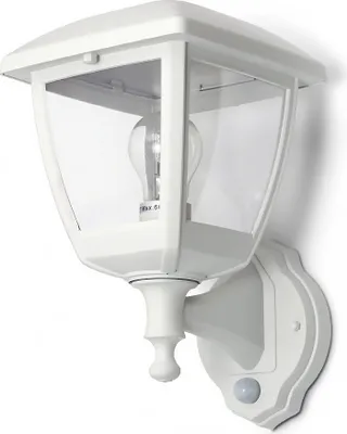 A white outdoor wall lamp with a clear glass enclosure and a visible light bulb, mounted on a wall.