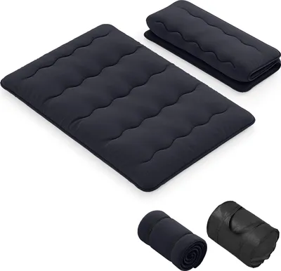 A black futon mattress is shown laid out flat, with another folded mattress behind it. Below, two rolled-up mattresses are displayed, one in a carrying bag.