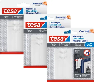 Three packages of tesa Powerstrips adhesive nails for hanging items on walls.