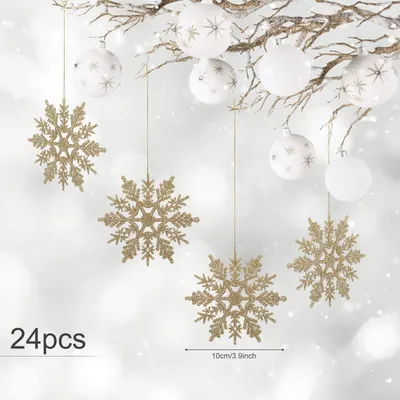 Christmas snowflake ornaments hanging from branches with white baubles.