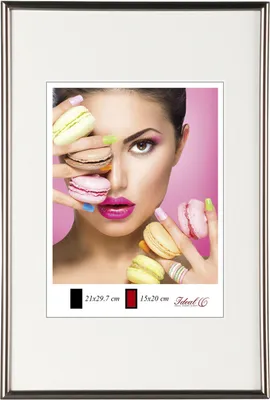 A woman is holding macarons in front of her face, with a pink background.
