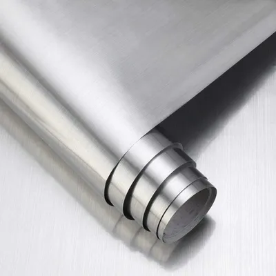 A roll of brushed silver metallic adhesive film, partially unrolled, showing the texture and sheen of the material.