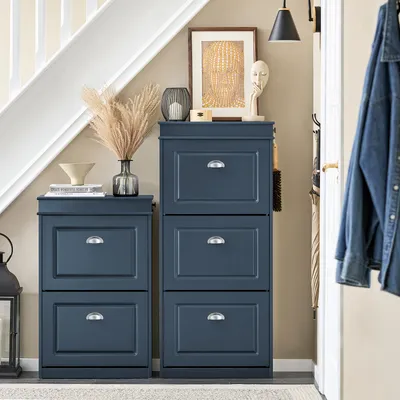 A hallway with a blue shoe cabinet, a staircase, and a denim jacket hanging on a hook.
