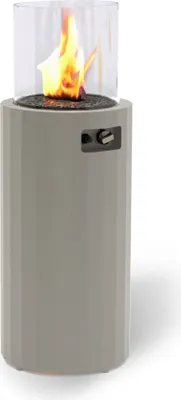 A gray cylindrical outdoor heater with a glass enclosure containing a flame.