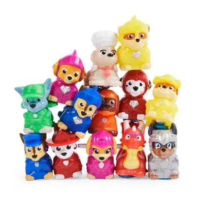 A collection of small toy figures stacked in a pyramid formation against a white background.
