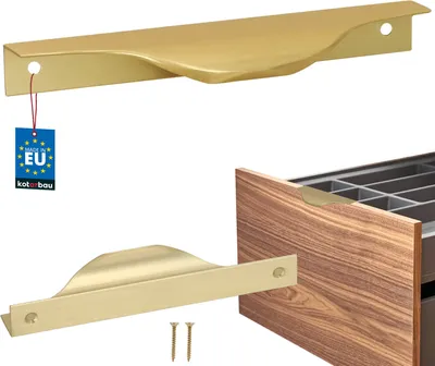 A close-up view of two gold cabinet handles, one shown on its own with a tag, and another installed on a wooden drawer.