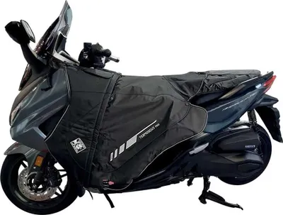 A scooter with a black leg cover attached.