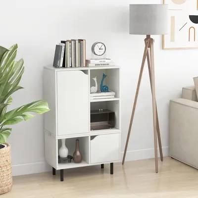 A white bookshelf with books and decorative items on top, next to a floor lamp.