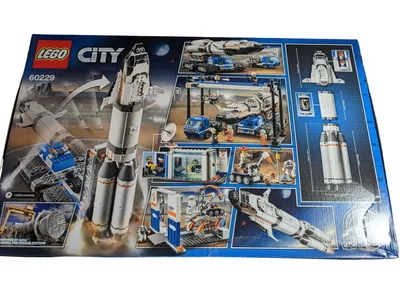 The image shows the back of a LEGO City 60229 Rocket Assembly & Transport set box, displaying various scenes and models from the set.
