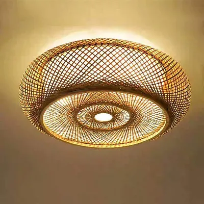 A close-up, low-angle shot of a woven bamboo ceiling light fixture.