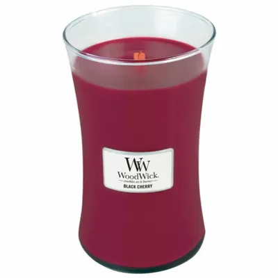 A WoodWick Black Cherry scented candle in a glass jar.