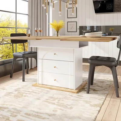 A dining table with a pull-out extension and storage drawers, set in a bright, modern dining room with large windows and a rug.