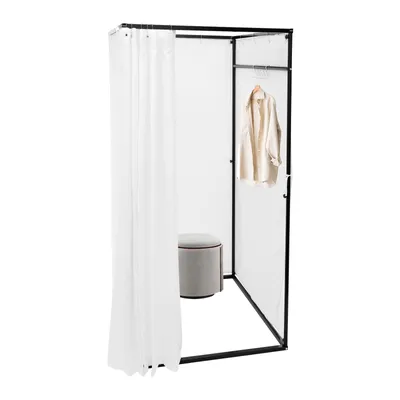 A freestanding changing room with a white curtain, a hanging garment, and a stool.