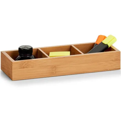 A bamboo desk organizer with three compartments, containing a bottle of ink, a stack of sticky notes, and two highlighters.