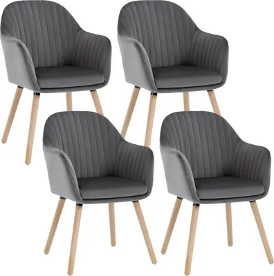 Four dark gray upholstered chairs with wooden legs are arranged in a studio setting against a white background.