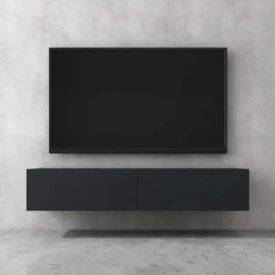 A modern, wall-mounted TV stand with a flat-screen television above it, set against a concrete wall.
