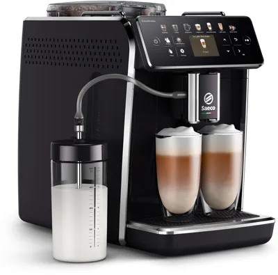 A black Saeco GranAroma coffee machine with a milk frother and two cups of coffee with foam.