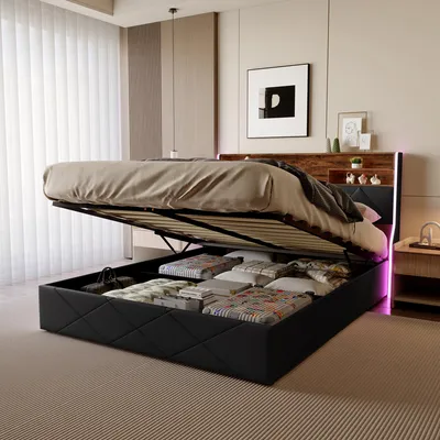 A modern bedroom with a bed that has its storage compartment open, revealing neatly folded items inside. The bed features LED lighting.