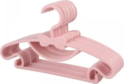 A stack of pink children's hangers with a bow detail.