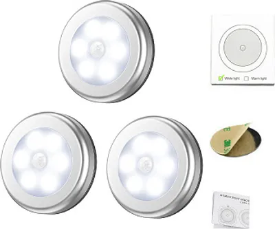 A product shot of three motion-sensor night lights and accompanying accessories.