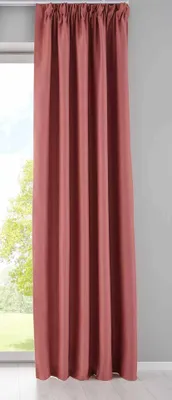 A full-length view of a pink curtain hanging in front of a window.