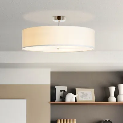 A ceiling light fixture is shown mounted on a white ceiling above a shelf with decorative items.