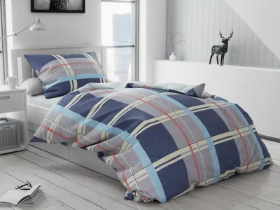 A neatly made bed with plaid bedding in a bright, modern bedroom.