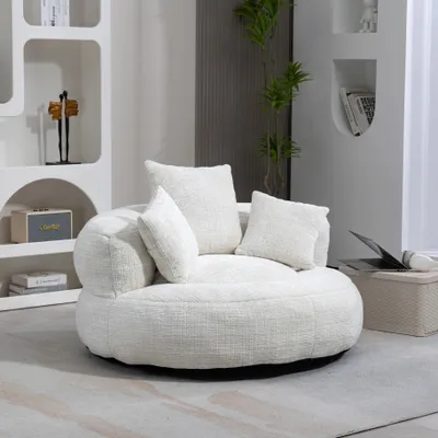 A white bean bag chair with pillows in a modern living room setting.