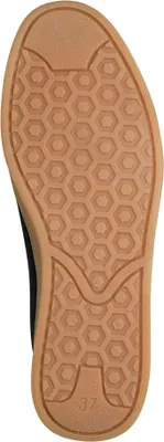 The underside of a black sneaker with a brown sole.