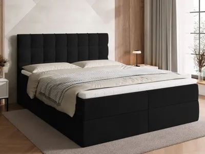 A black upholstered bed with a tufted headboard and two storage drawers, set in a bedroom with a textured wall and wooden accents.
