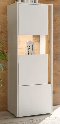 A tall, narrow white cabinet with a wood-grain background.