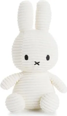 A white corduroy plush toy rabbit, known as Miffy, is shown against a white background.