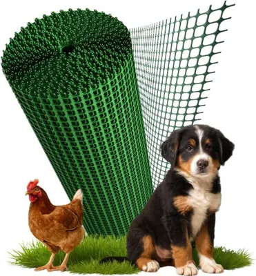 A roll of green plastic mesh fencing is shown next to a chicken and a puppy sitting on grass.