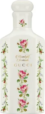 A white bottle of Gucci Moonlight Serenade Eau de Parfum with floral decorations.