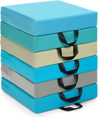 A stack of six square floor cushions in various colors, each with a black handle.