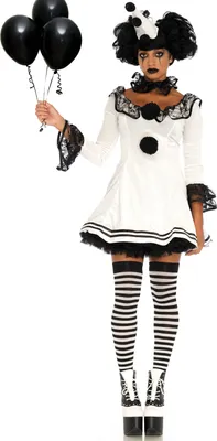 A woman dressed as a clown holding black balloons.