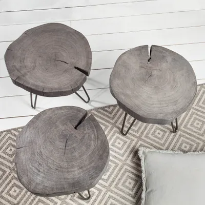 Three round wooden side tables with hairpin legs are arranged on a patterned rug.