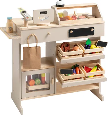 A wooden toy shop counter with various toy food items displayed in crates and on shelves.