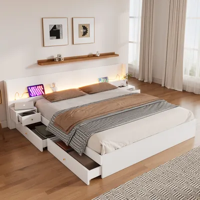 A modern white bed with integrated storage and LED lighting, set in a bedroom with curtains and artwork on the wall.