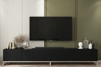 A modern living room with a TV stand and television.