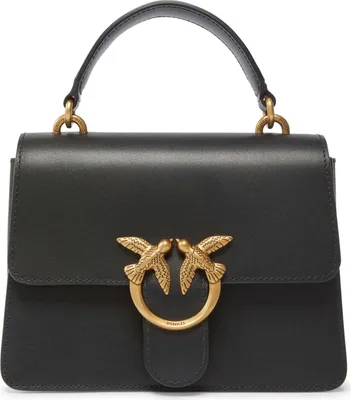 A black leather handbag with gold bird-shaped hardware.