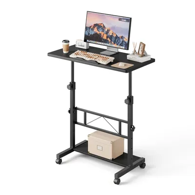 A black adjustable standing desk with a computer, keyboard, and coffee cup on top, shown against a white background.