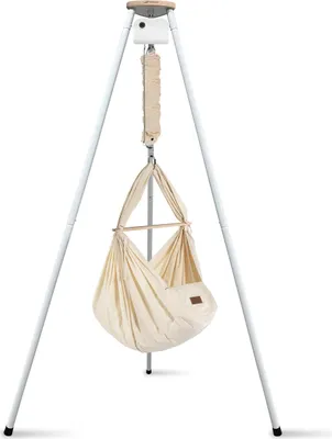 A baby hammock suspended from a white tripod stand.