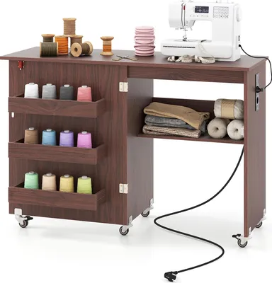 A sewing table with a sewing machine and various sewing supplies.