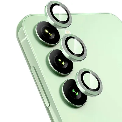 A close-up view of several camera lens protectors on a light green smartphone.