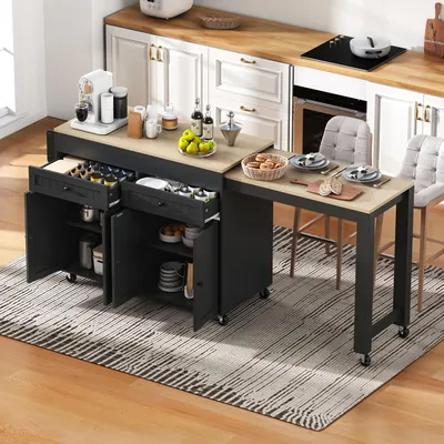 A kitchen island with an extendable countertop is set up in a kitchen, with food and drinks on it, and chairs pulled up to the extended section.