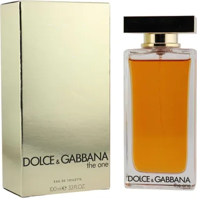 Parfum Dolce & Gabbana The One in rechteckigem Glasflakon mit goldener Verschlusskappe, daneben die glänzende Verpackung in Goldoptik.